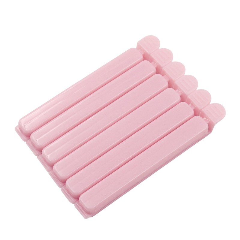 Small pink eco - friendly plastic bag clips with super - strong clamping force, which can keep food fresh for longer. A must - have kitchen gadget.